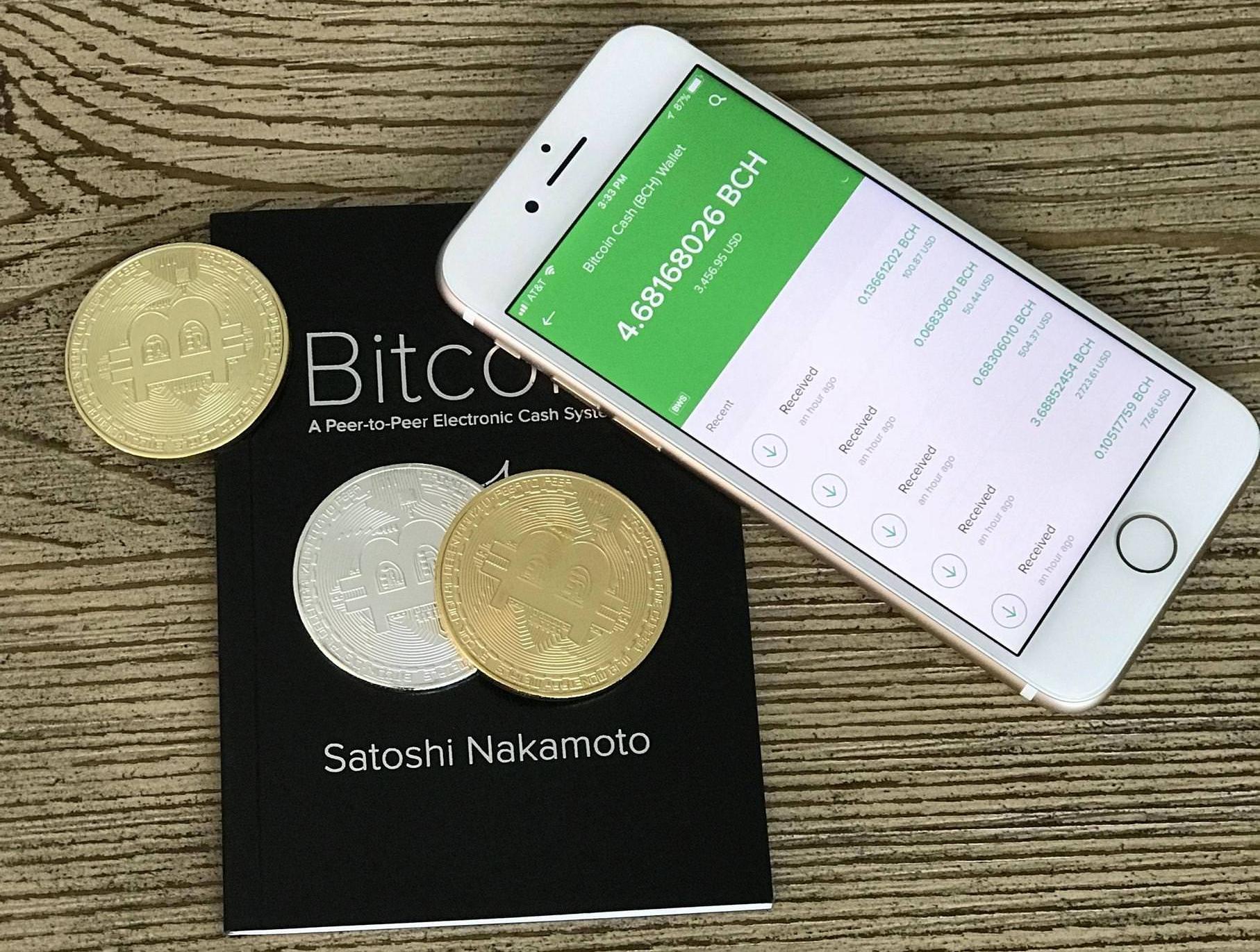 Bitcoin Cash wallet and whitepaper.jpg English: Photo of a mobile phone with a Bitcoin Cash wallet, Bitcoin whitepaper by Satoshi Nakamoto