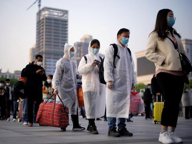 Travellers line up with their belongings outside Hankou Railway Station after travel restrictions to leave Wuhan, the capital of Hubei province and China's epicentre of the novel coronavirus disease (COVID-19) outbreak, were lifted. Photo: Reuters