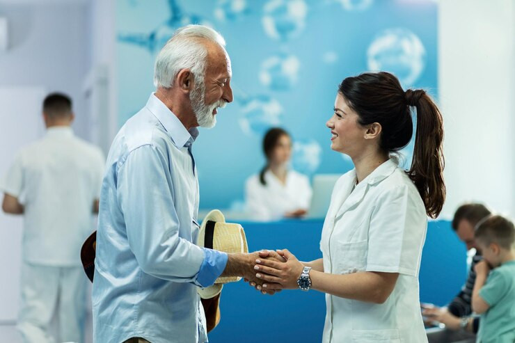 happyseniormanhandshakingwithfemaledoctorwhiletalkinglobbyclinic_637285460.jpg