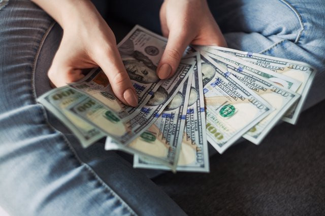 personholding100usdollarbanknotes2068975.jpg
