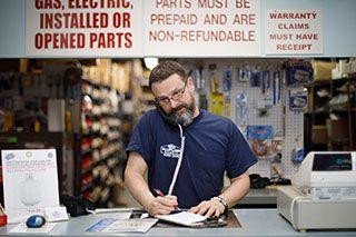 bluflametechniciantakingorderforretailhvacparts.jpg