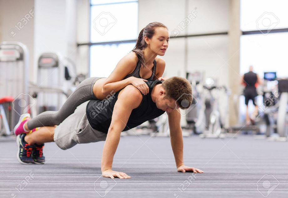 35053108fitnesssporttrainingteamworkandlifestyleconceptsmilingcoupledoingpushupsinthegym.jpg